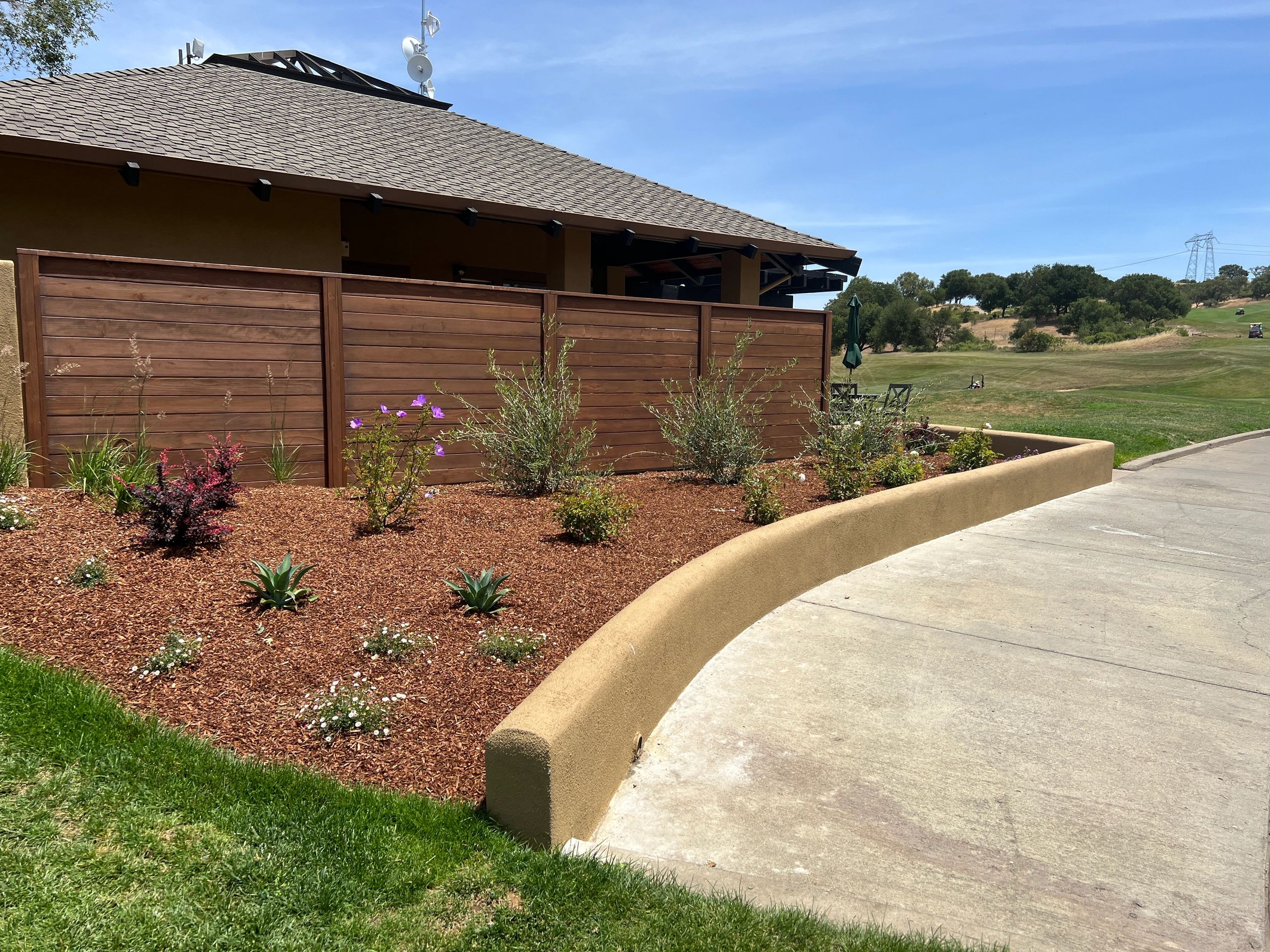 Building with wooden fence and garden