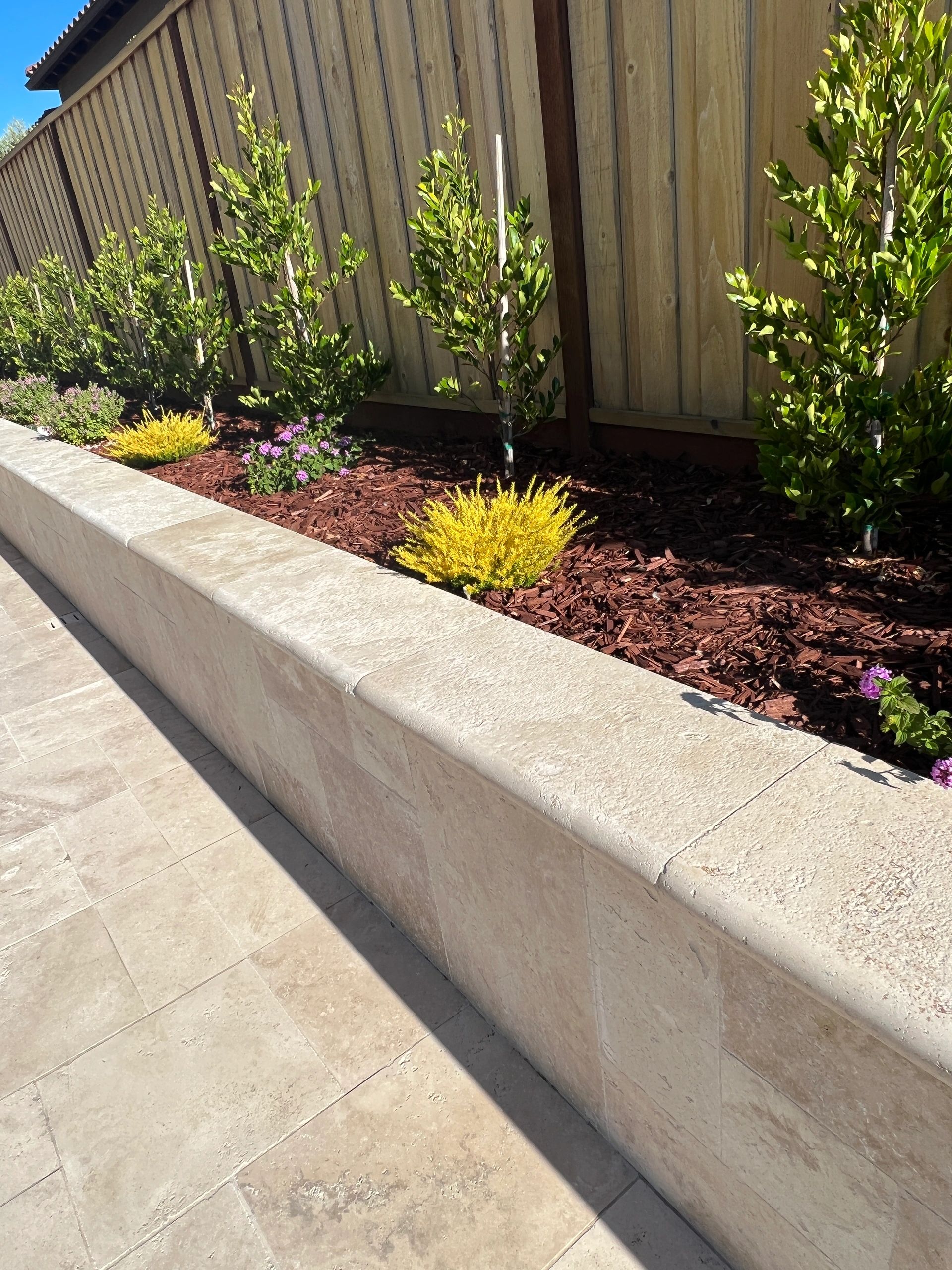 Stone wall beside vibrant garden