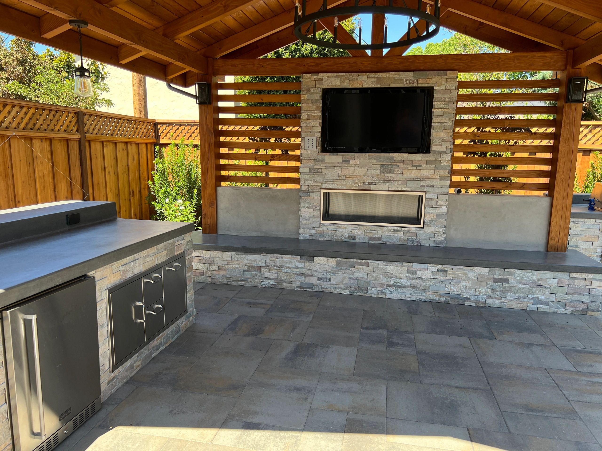 Covered outdoor seating area with TV