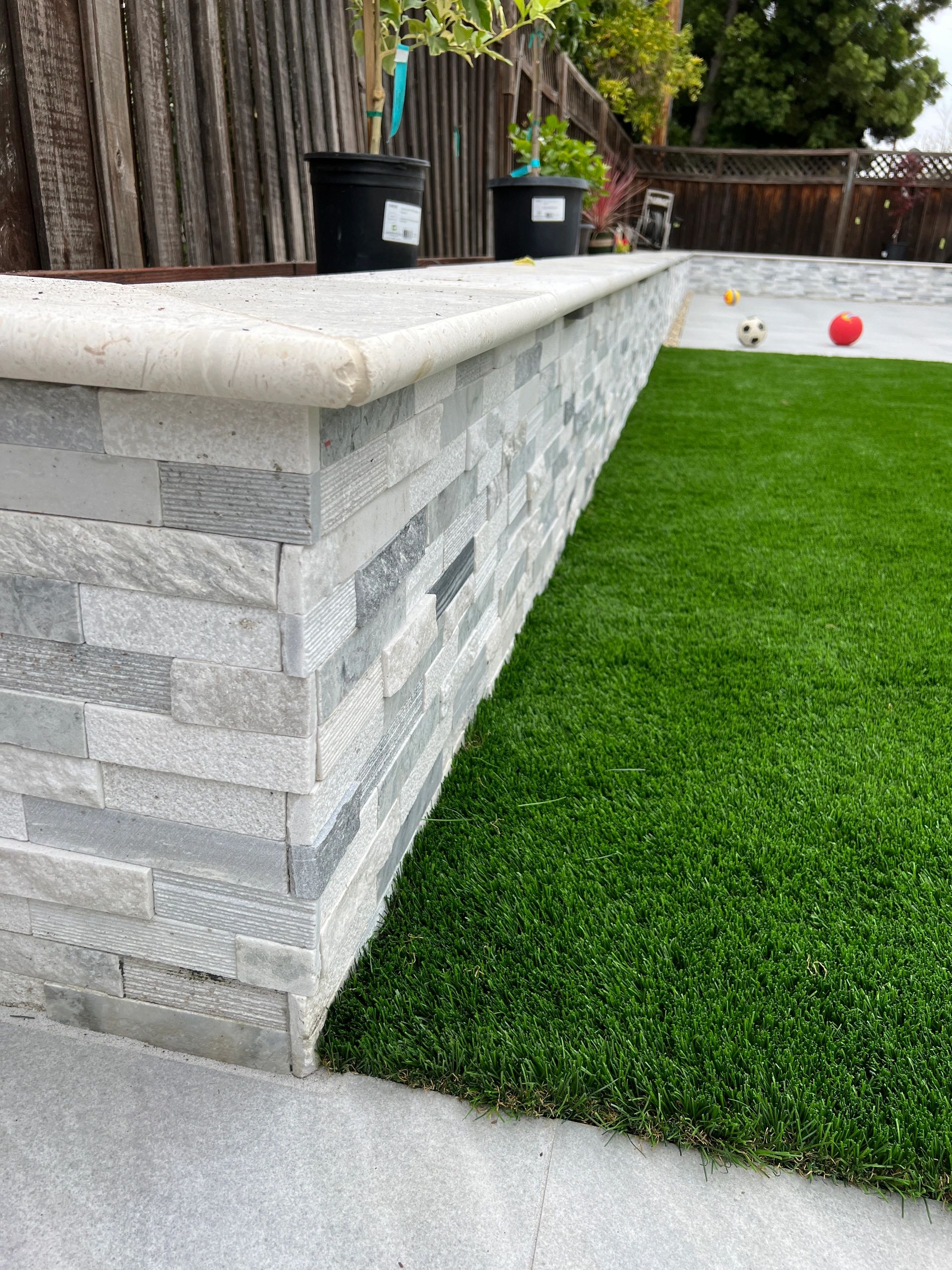 Patio featuring stone and green lawn