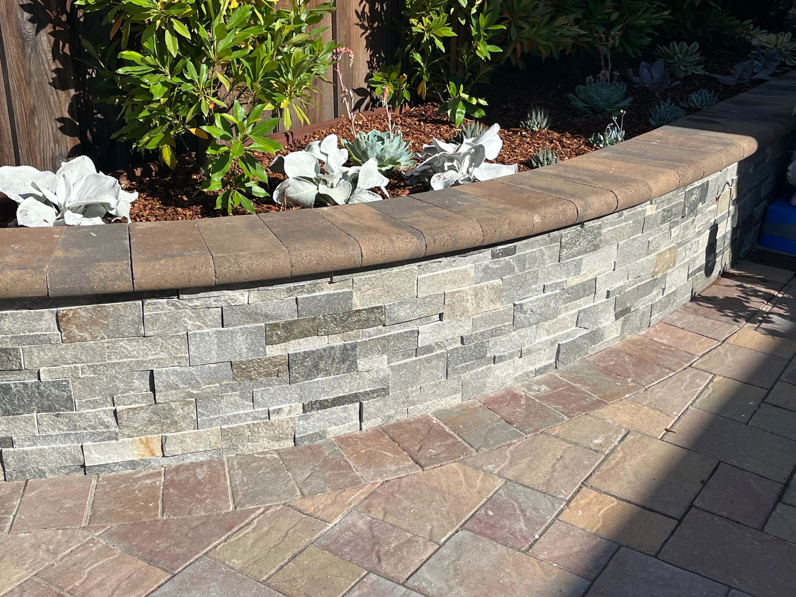 Curved stone wall in garden
