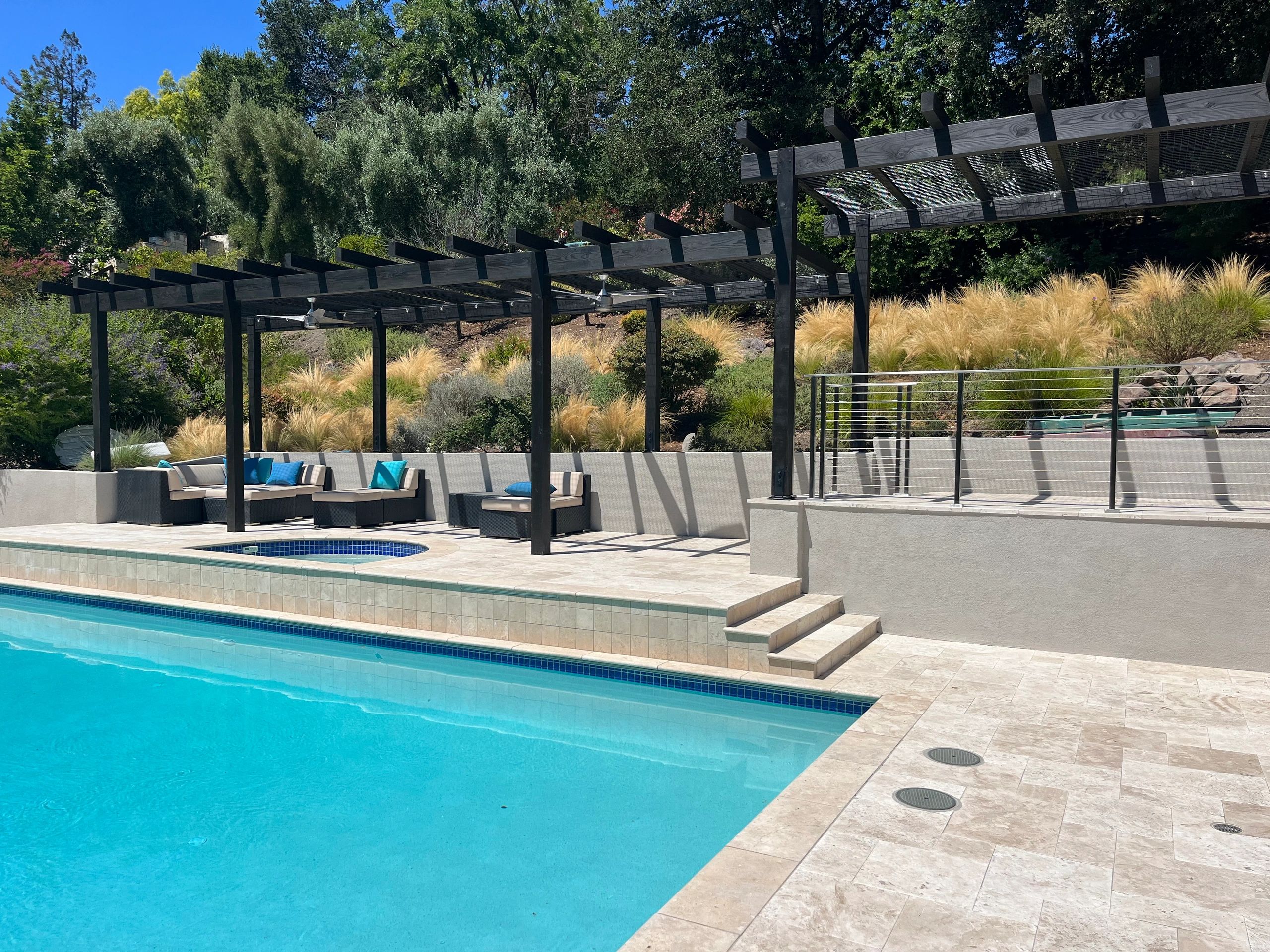 Outdoor pool with pergola and seating area