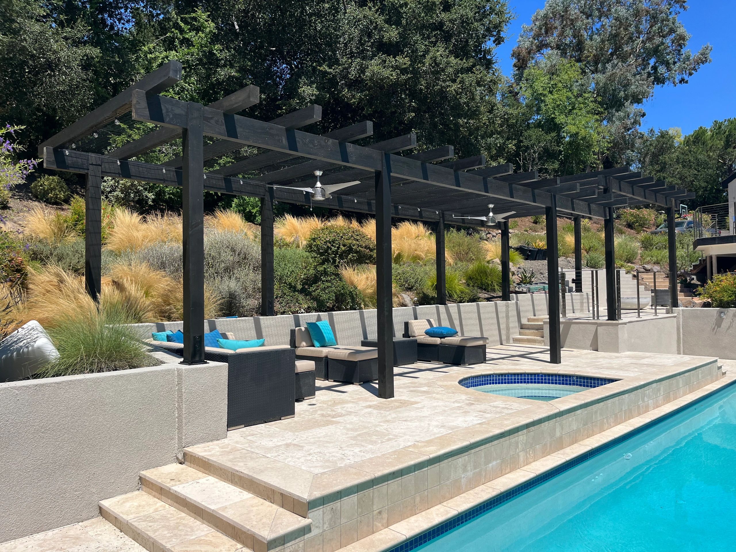 Modern poolside patio with pergola