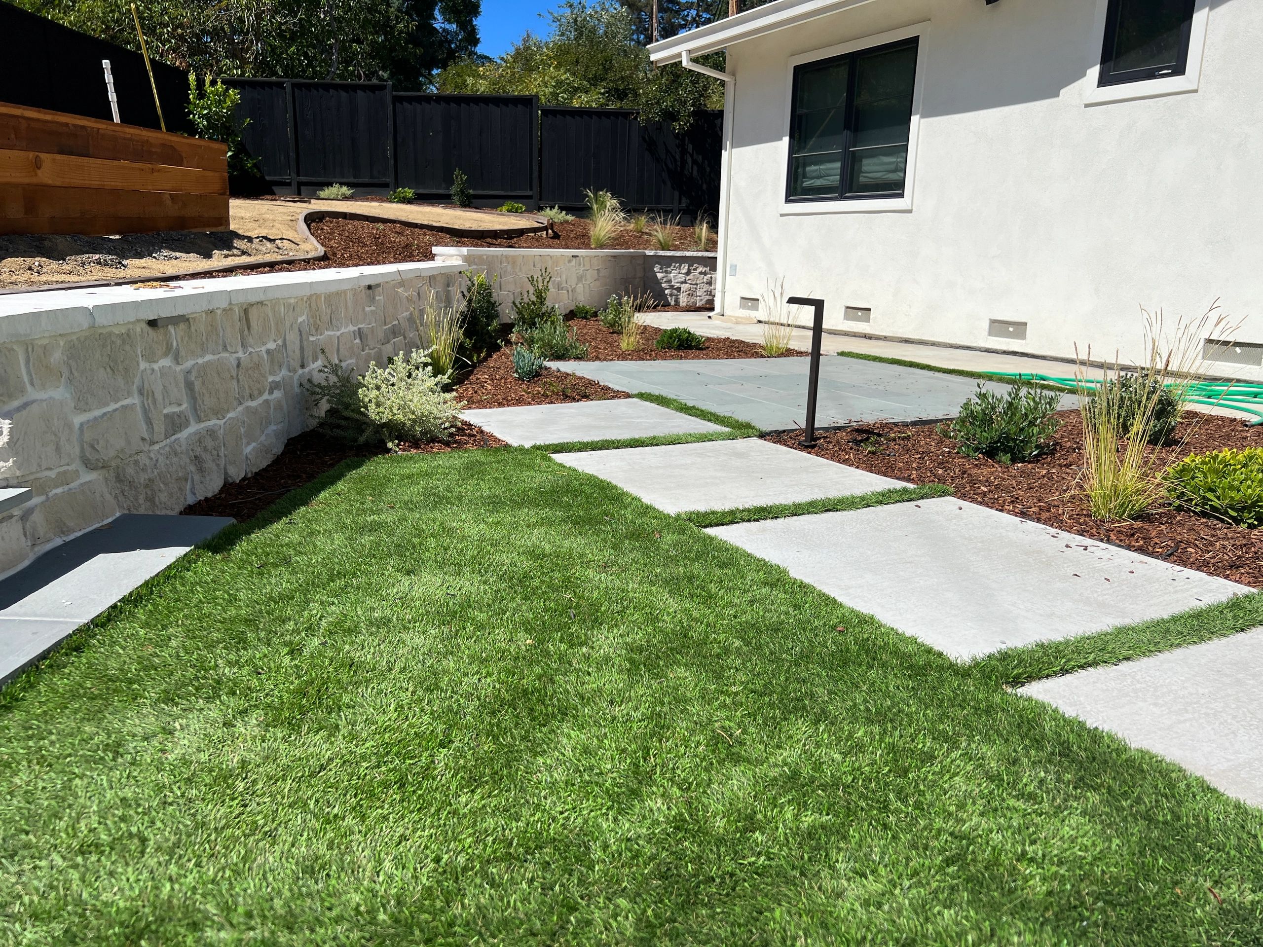 Modern landscaped backyard with stone path