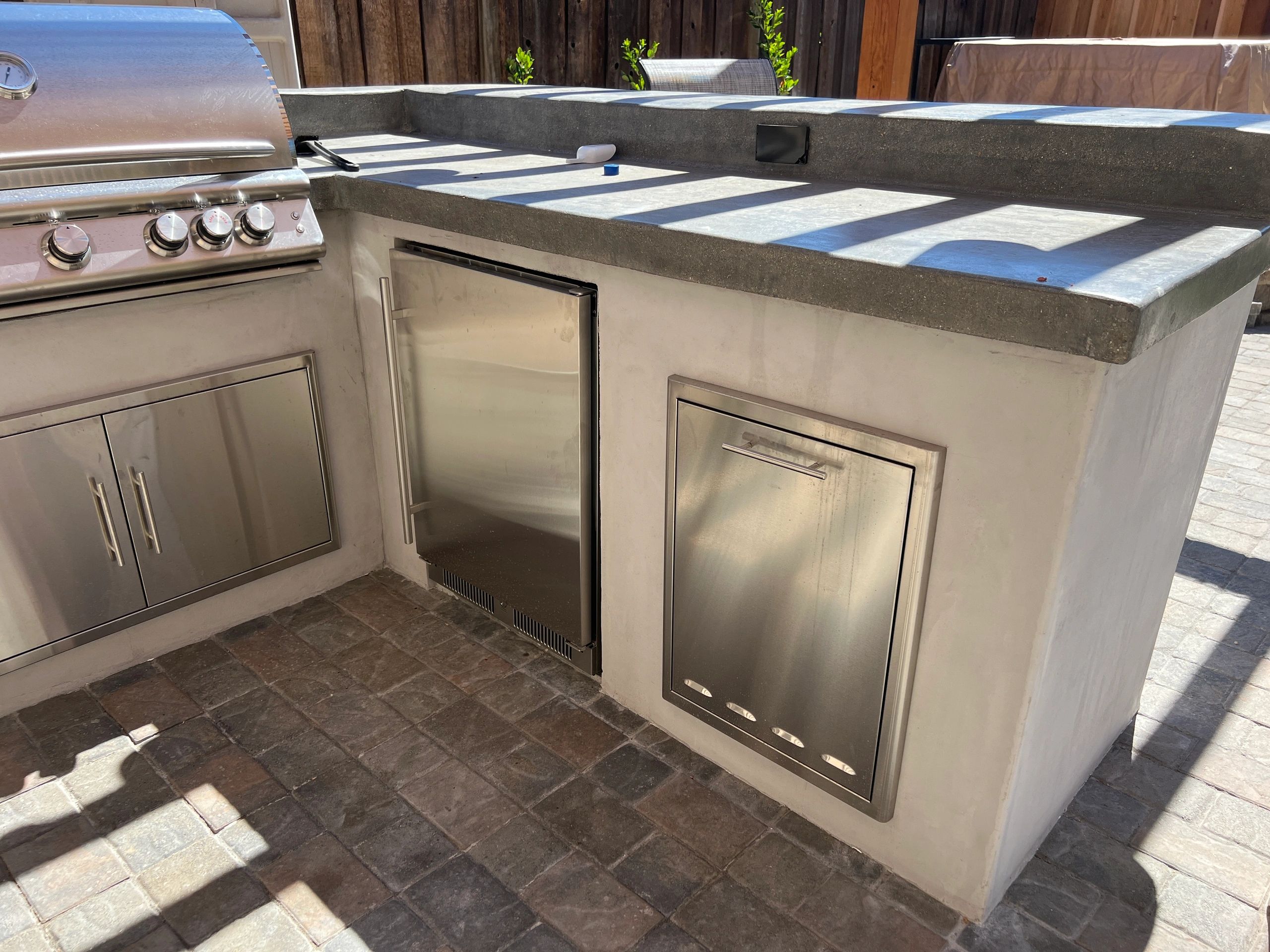 Modern outdoor cooking area with cabinets