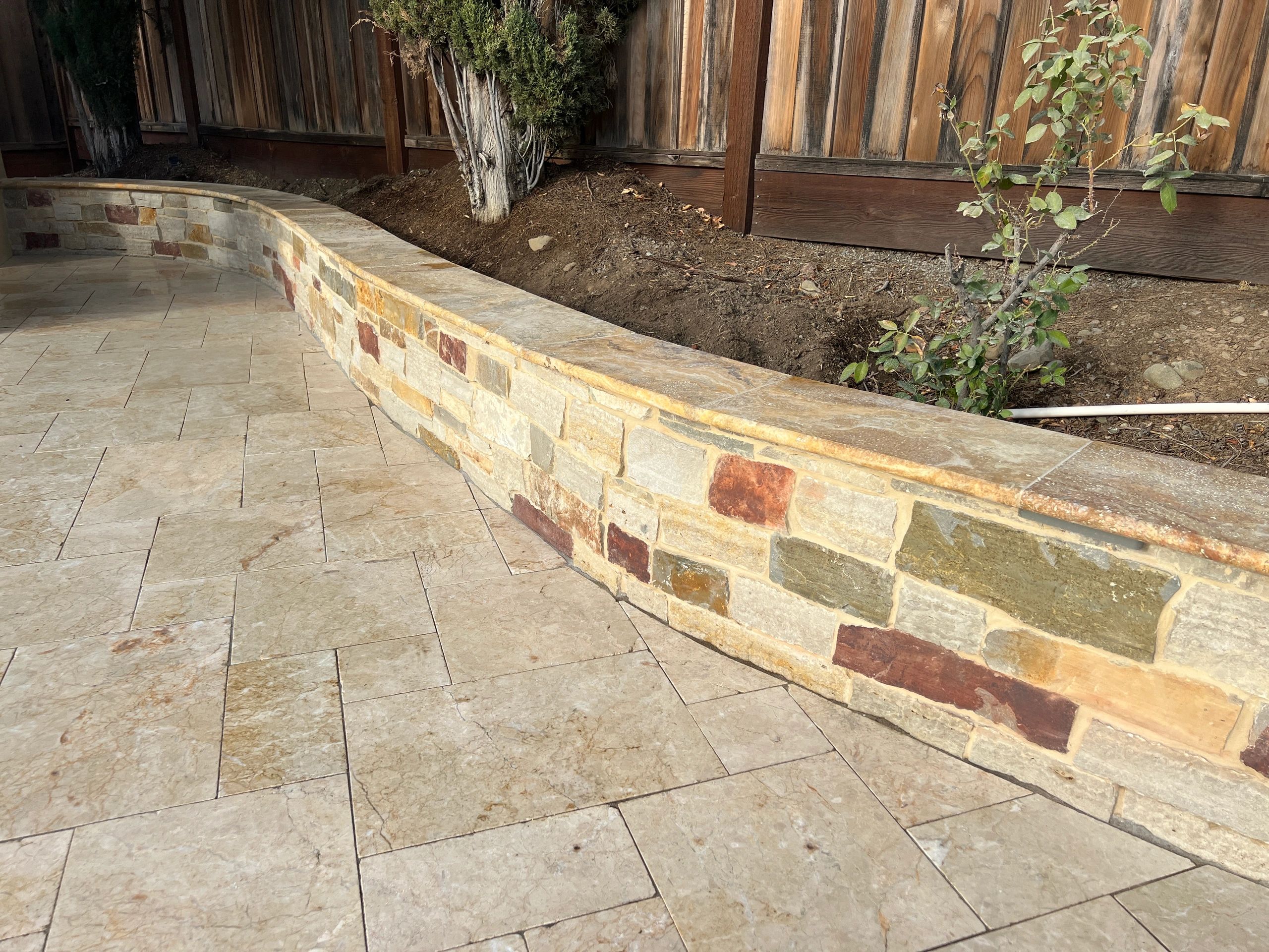 Garden patio with decorative stone wall