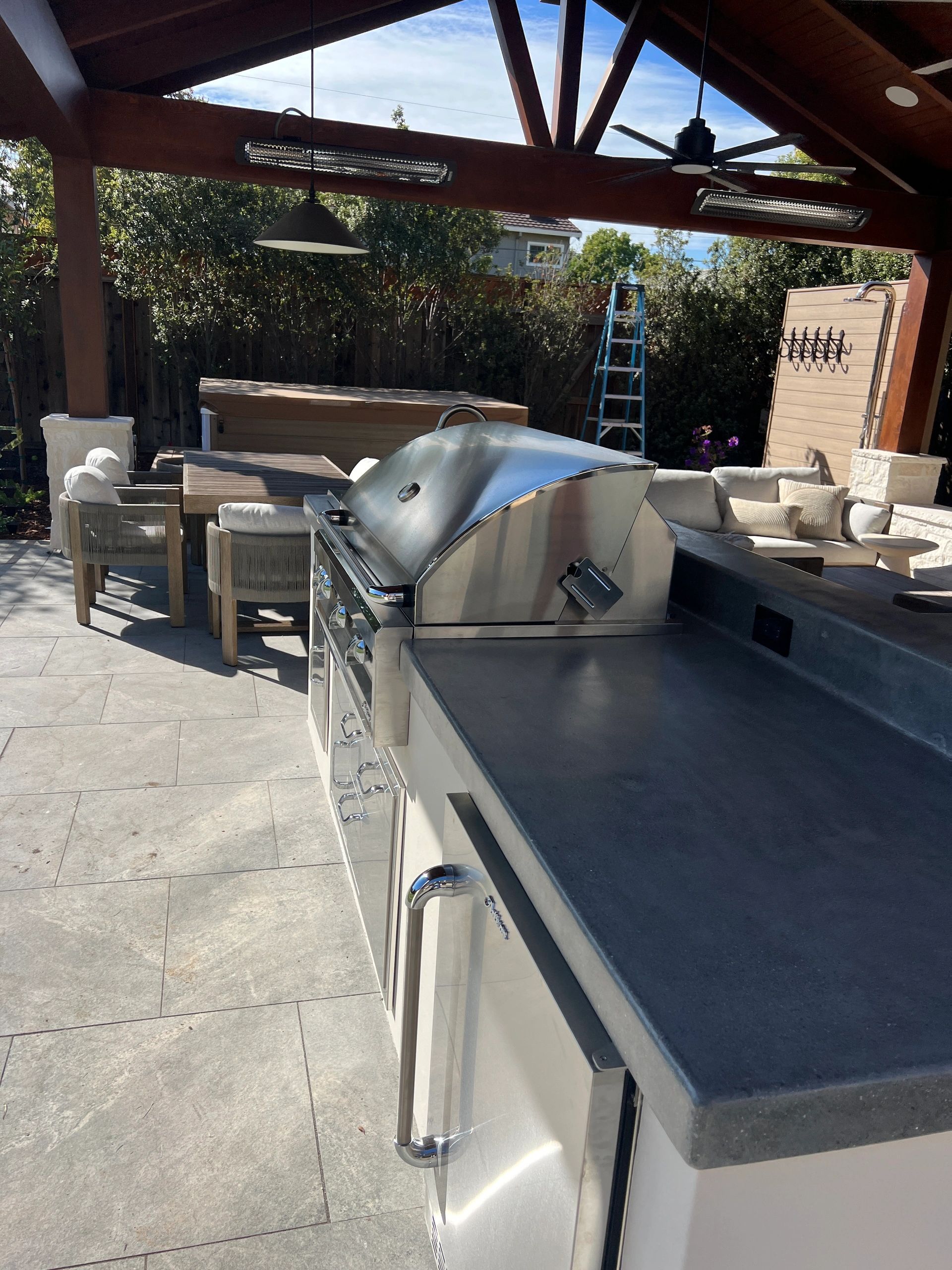 Covered patio featuring a large outdoor grill.