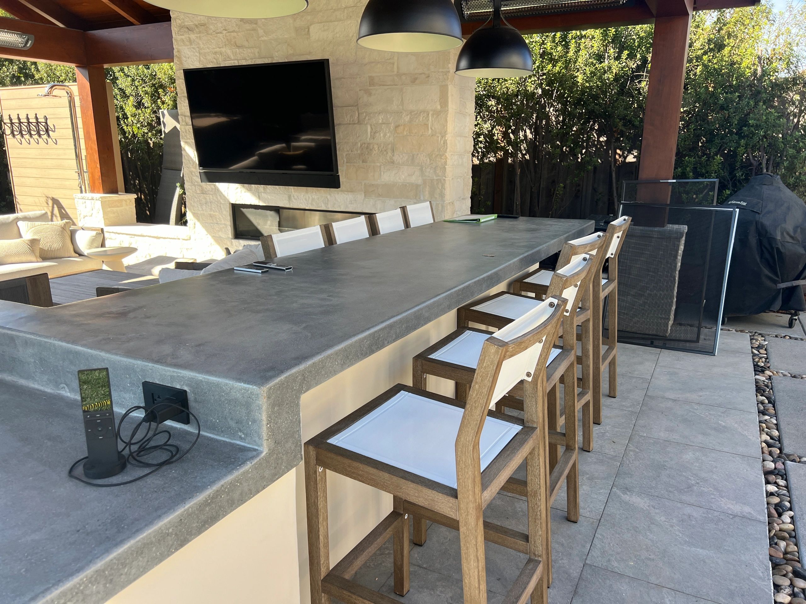 Modern outdoor kitchen area with stools