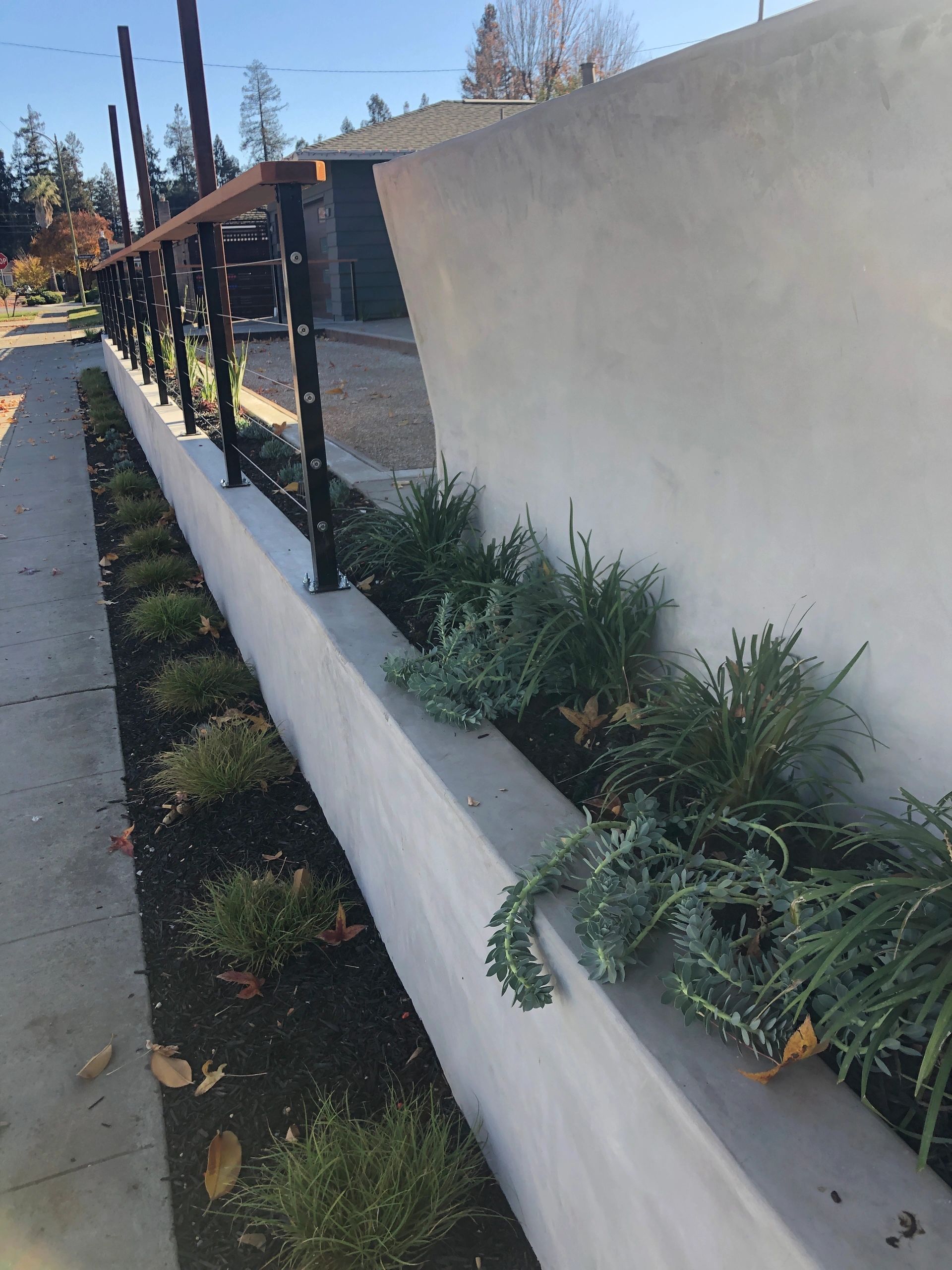 Modern concrete wall with metal railing