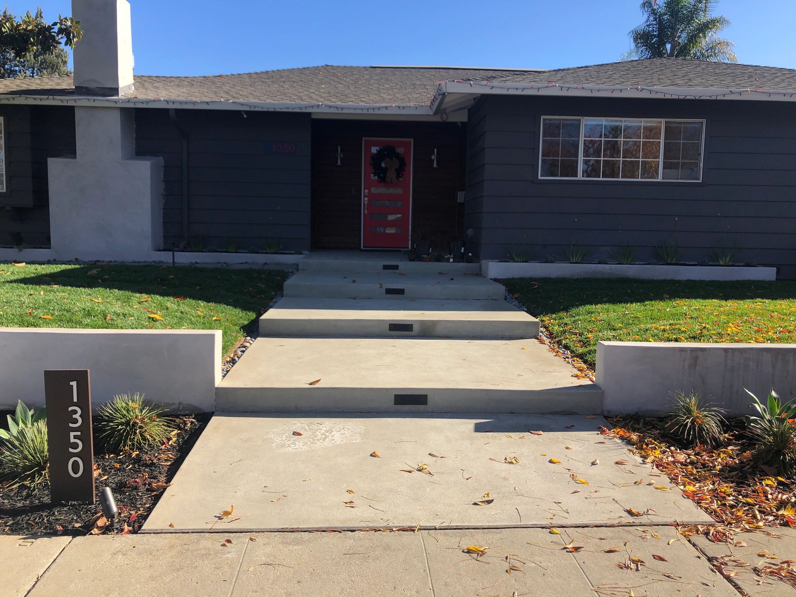 Dark gray house with front lawn