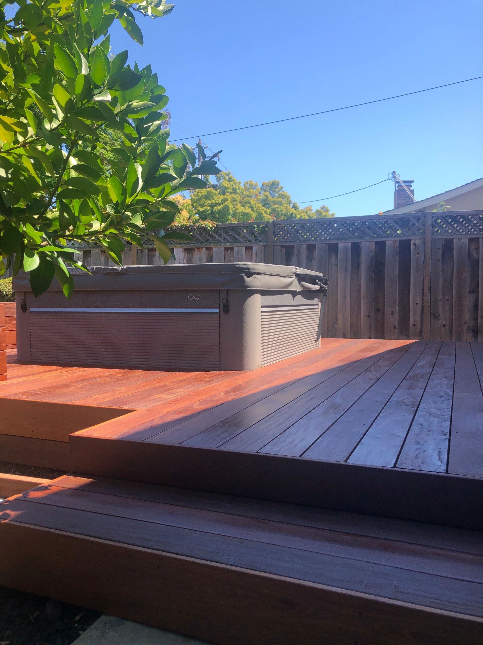 Backyard wooden deck with hot tub