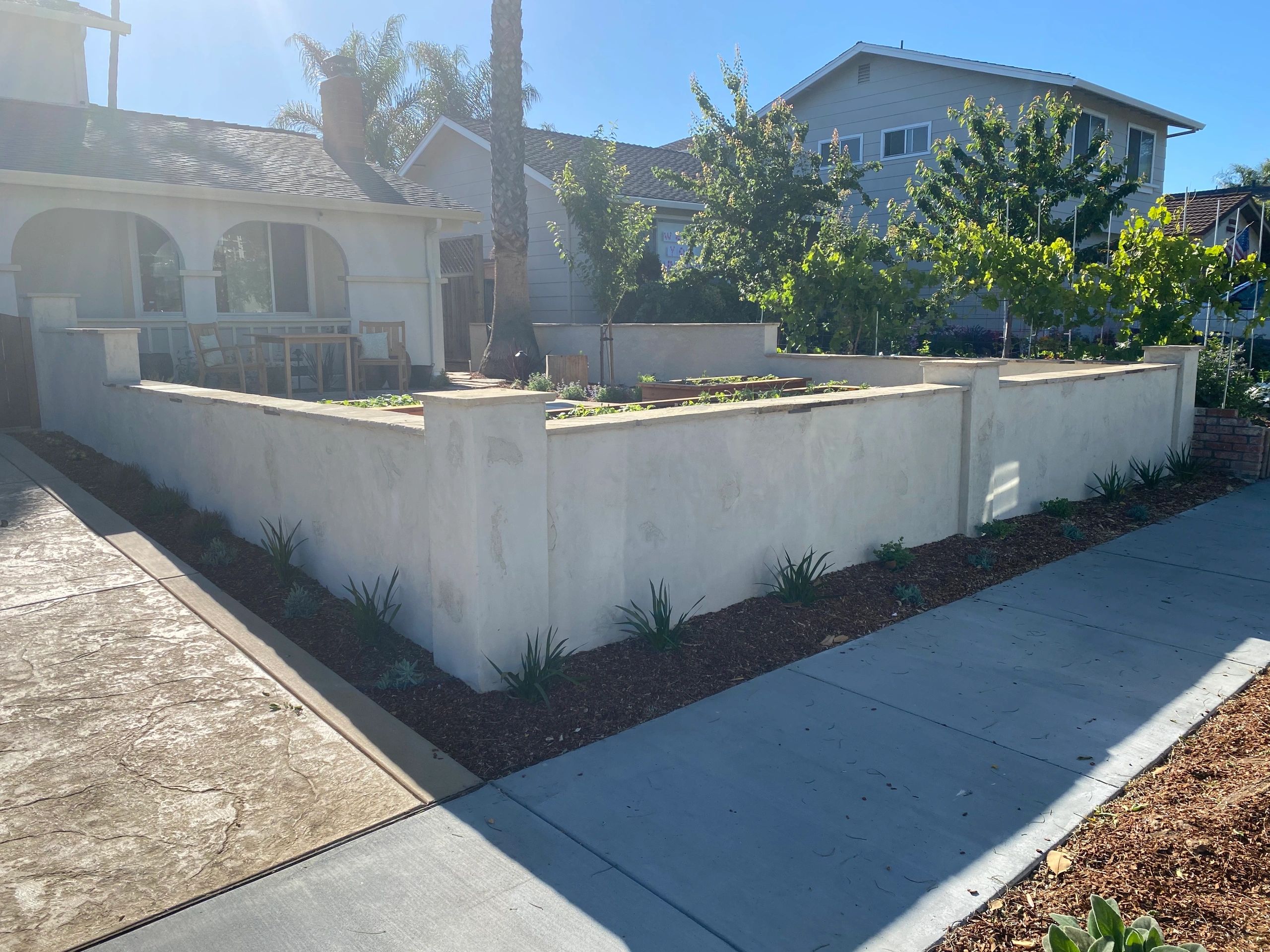 Front yard with white stucco wall