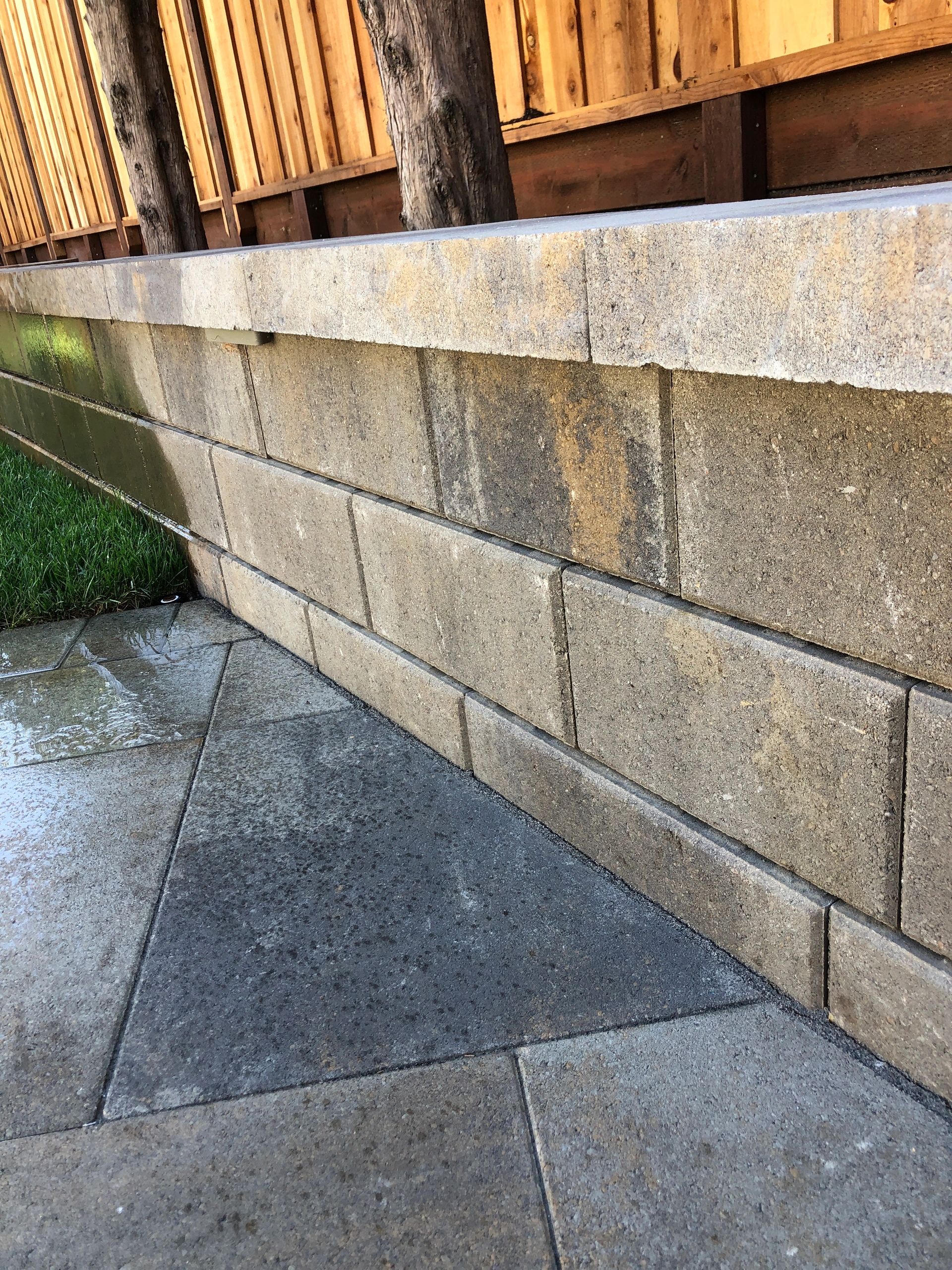 Concrete wall with grass and pavement