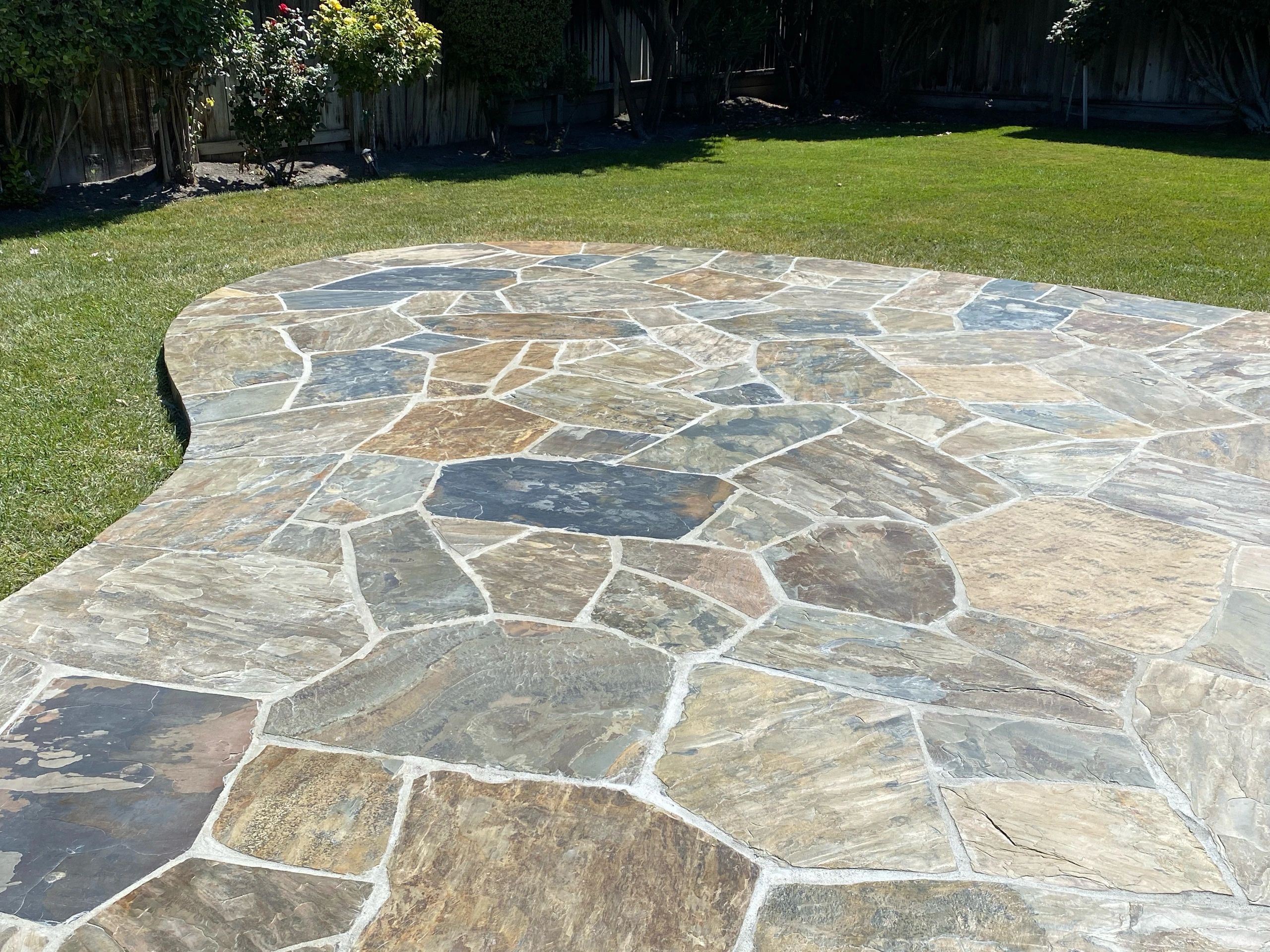 Flagstone patio in sunny backyard