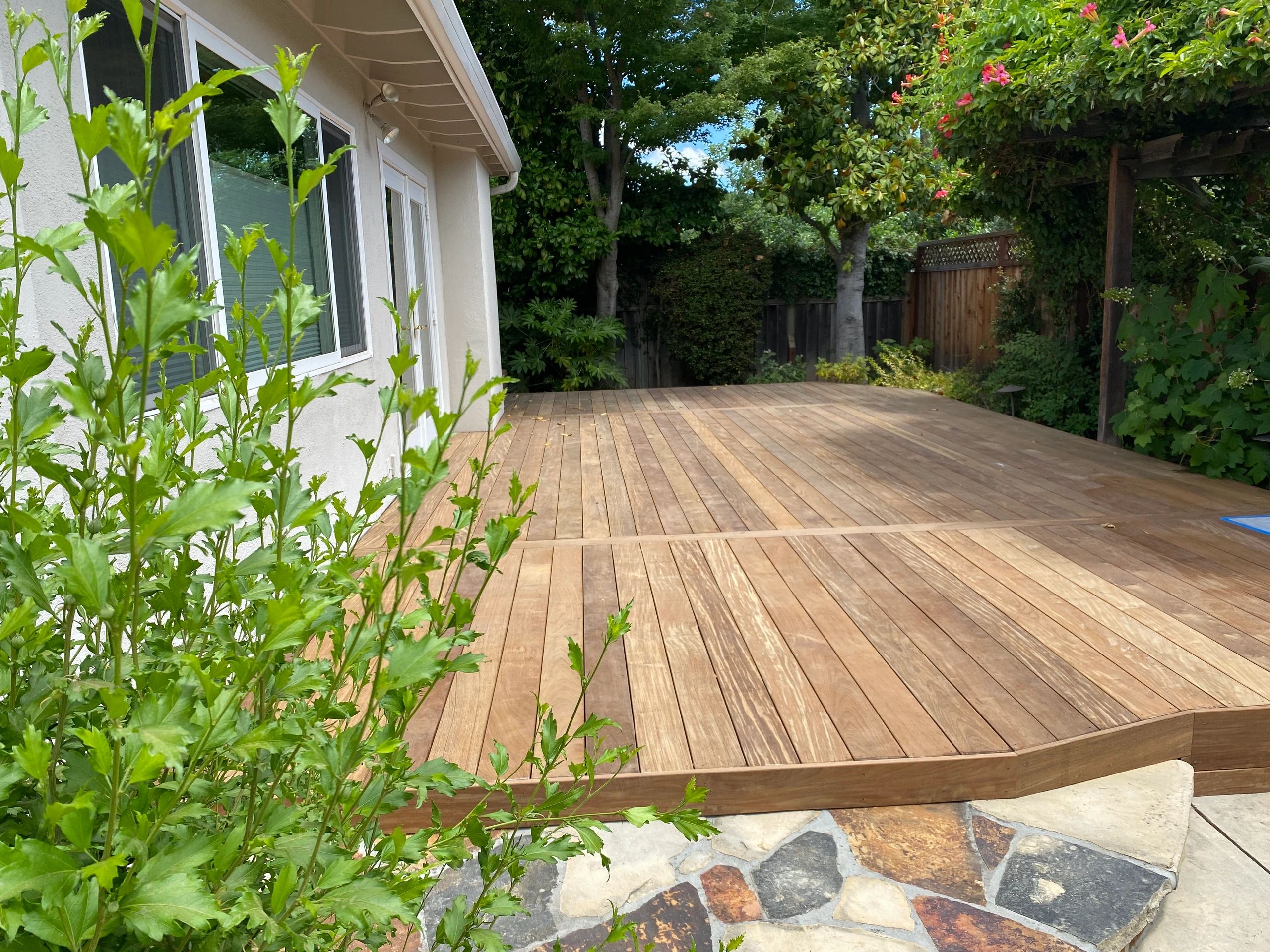 Spacious backyard deck with greenery