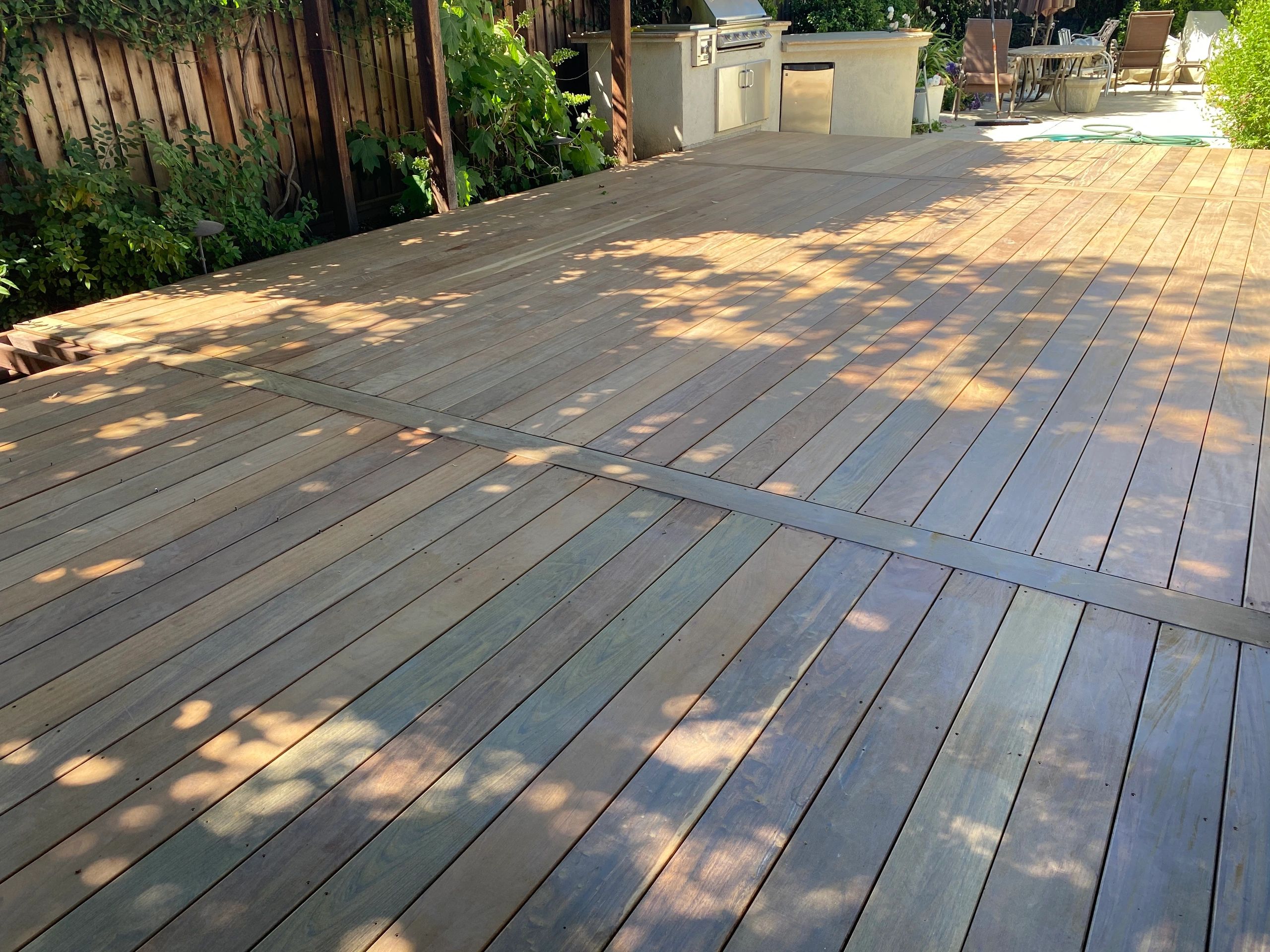 Spacious backyard patio with trees
