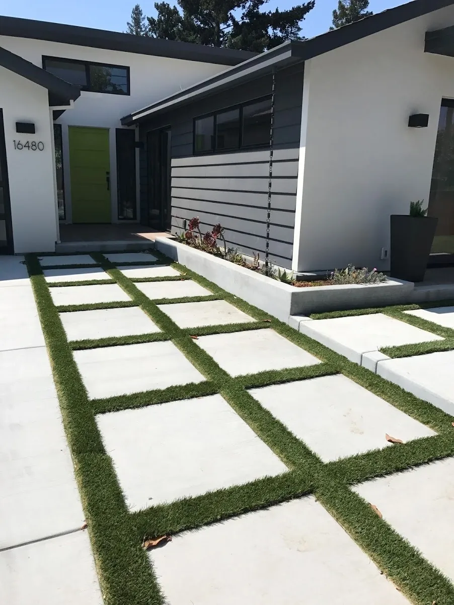Sleek architecture featuring grass and concrete path