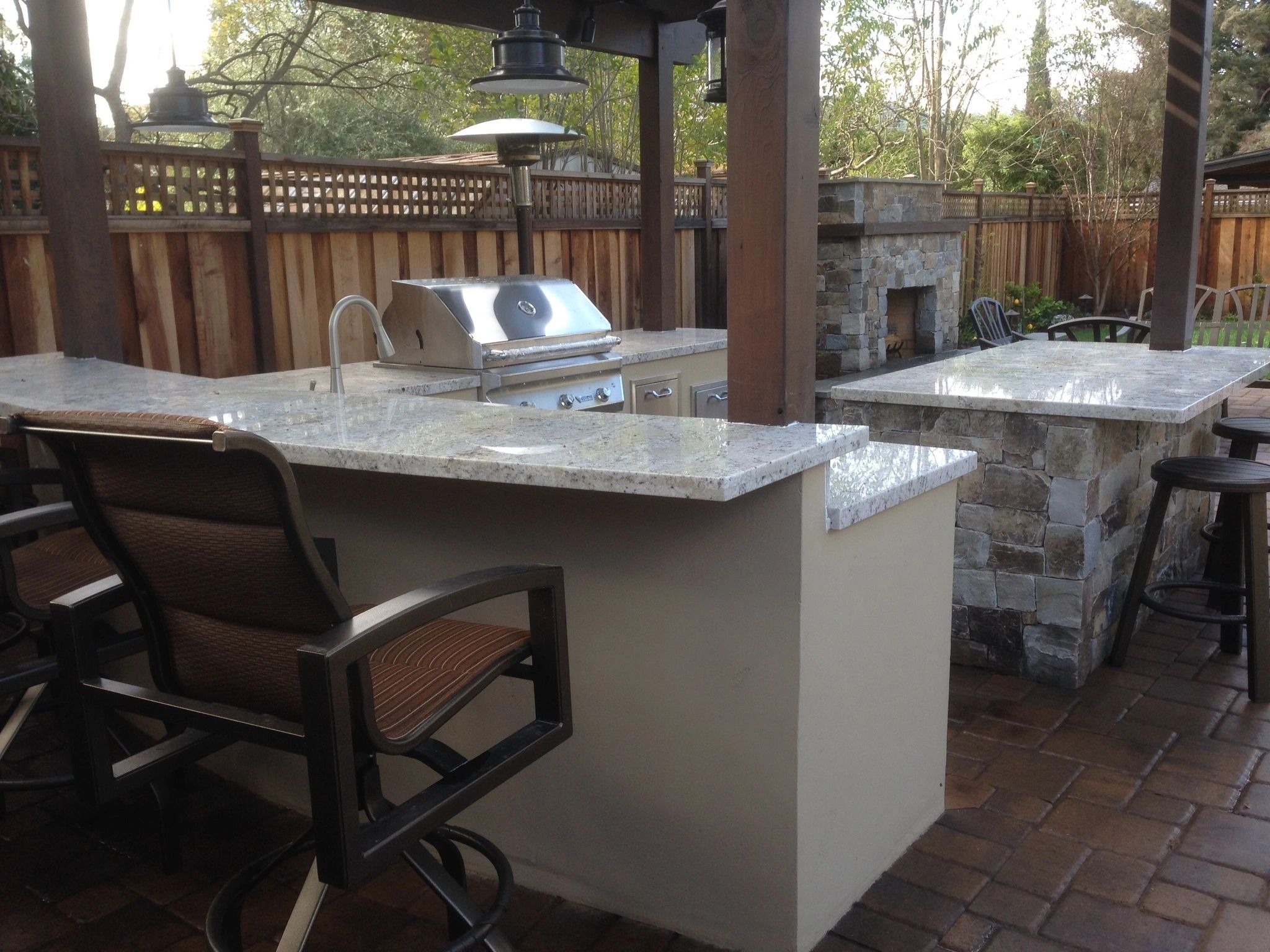 Outdoor kitchen with grill and seating