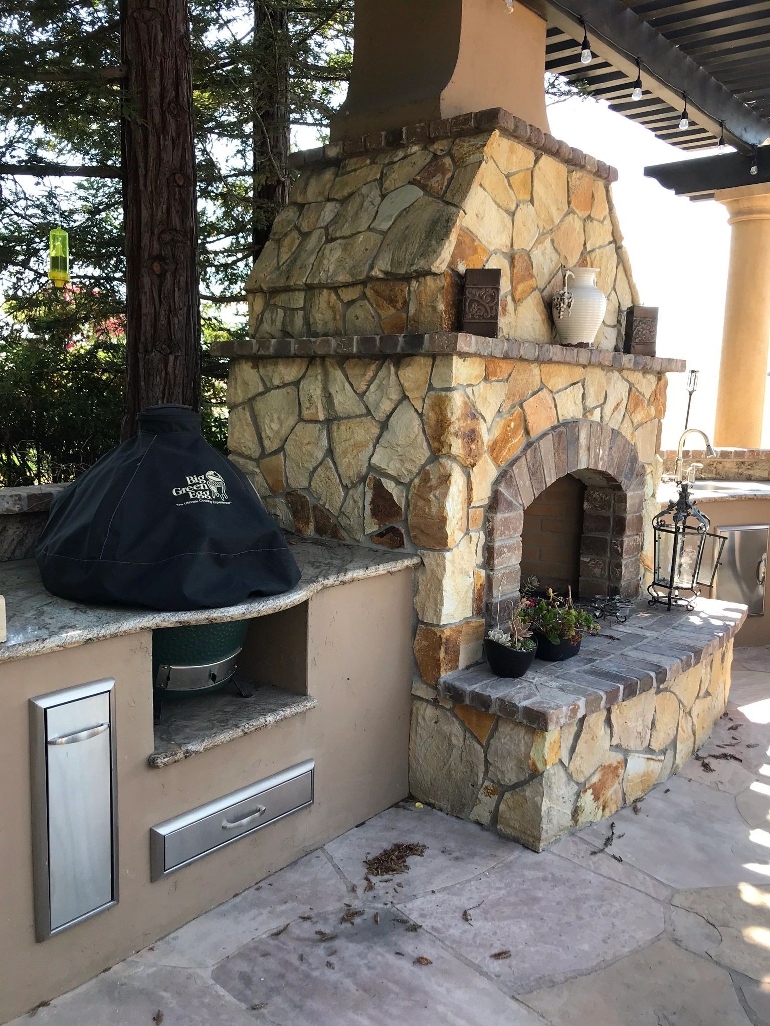 Rustic patio with stone fireplace