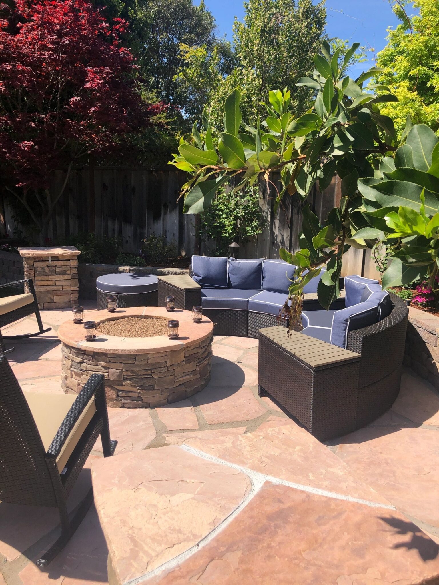 Garden patio with circular stone fireplace